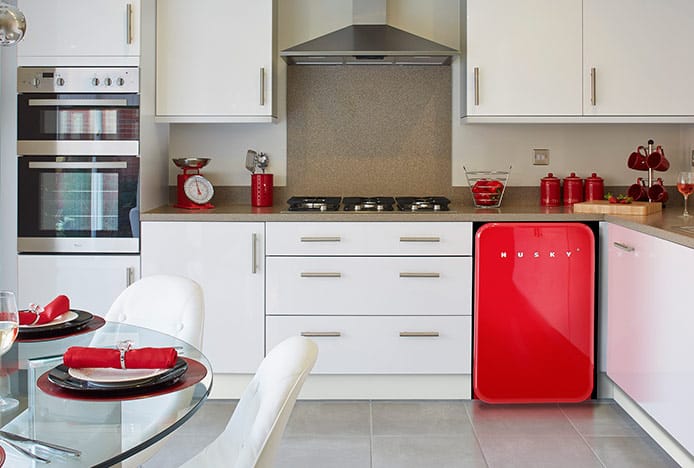 Cushioned Eames Chairs in Red and White Kitchen